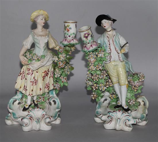 A pair of Derby candlestick figures of flower sellers, c.1770, pad marks, losses